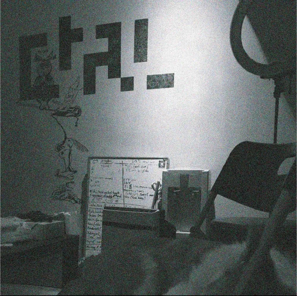 A corner of the studio, the logo in black squares on the wall.
